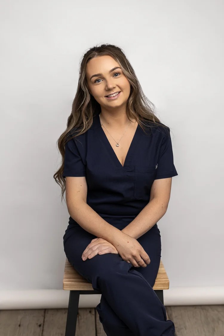 Georgina White seated in her nursing uniform