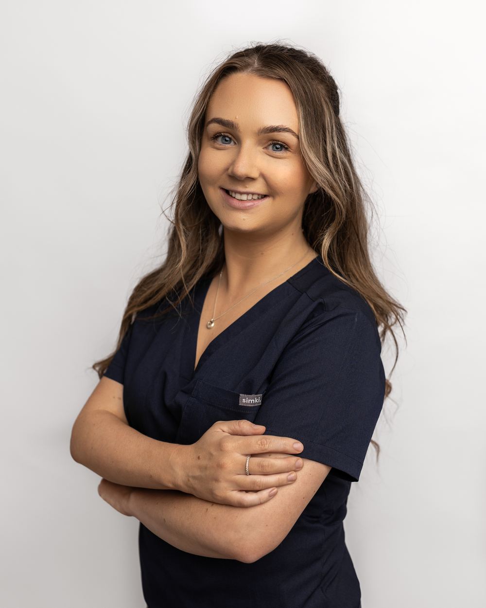 Georgina White, registered nurse, standing with her arms folded